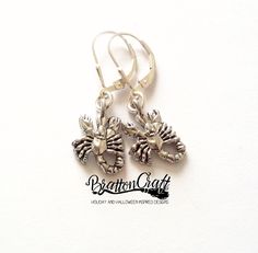 "I love the detail of the eyes, claws, legs, and tail on these Silver Scorpion Earrings! This little guy/gal is made of pewter in the USA with an antique silver finish. The scorpion measures 5/8 inches long and 1/2 inch wide. The leverback earwire is sterling silver with a tear drop accent. This Scorpio necklace is ready to ship and will arrive in a gift box. View other BrattonCraft® Zodiac jewelry here: https://www.etsy.com/shop/BrattonCraft?ref=seller-platform-mcnav&search_query=zodiac Bac Novelty Silver Pierced Earrings, Novelty Metal Earrings With Ear Wire, Scorpion Jewelry, Scorpion Earrings, Irish Earrings, Zodiac Earrings, Celtic Circle, Scorpio Necklace, Celtic Knot Jewelry