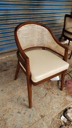 two chairs sitting next to each other in front of a building