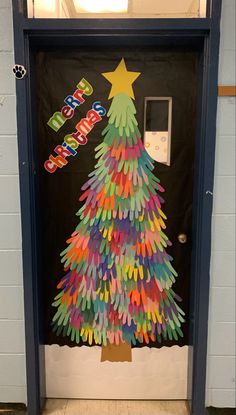 a decorated christmas tree is on the door to an office building with its name written on it