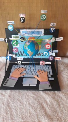 an open laptop computer sitting on top of a bed covered in stickers and magnets