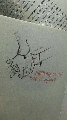 an open book with writing on it and a drawing of two hands holding each other