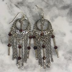 These OOAK chain dangles are made with beautiful amethyst Swarosvki bicone crystals, glass swirl bugle beads, & non-tarnishing, stainless steel chain.  They hang 2 3/4 inches in length on beautiful silver connectors with French ball ear wires.  They're absolutely stunning and can be worn year round Purple Metal Dangle Earrings, Purple Dangle Metal Earrings, Chandelier Dangle Earrings With Dangling Charms For Gift, Silver Crystal Earrings With Dangling Beads, Silver Beaded Pierced Earrings, Silver Round Crystal Earrings With Dangling Beads, Gift Chandelier Dangle Earrings With Charms, Silver Metal Beaded Earrings, Metal Chandelier Earrings With Dangling Beads