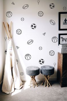 two stools in front of a wall with sports balls and basketballs on it