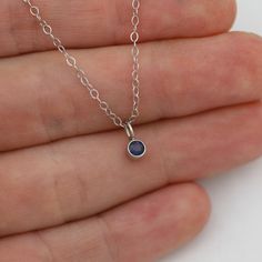 Very classy, simple, and dainty. This handcrafted gold pendant has a natural Sapphire stone and comes on your choice of a 16 inch or an 18 inch 14kw gold chain. It can also be paired with other pendants! Mix and match to create your own personalized necklace or mother necklace! Gold is 14k white with a rhodium plating. Stone measures 3mm in diameter. Birthstone for September. All Laine Benthall jewelry comes with a lifetime warranty. This pendant can also be purchased without the chain, just go White Gold Sterling Silver Round Birthstone Necklace, Minimalist Sterling Silver Gemstone Necklaces, Minimalist Sterling Silver Gemstone Necklace, Sterling Silver Solitaire Necklace With Round Pendant For Everyday, White Gold Sterling Silver Birthstone Necklace, Minimalist 14k White Gold Jewelry With Polished Finish, Minimalist White Gold Birthstone Necklace With Delicate Chain, Simple White Gold Jewelry With Polished Finish, Simple Polished White Gold Jewelry