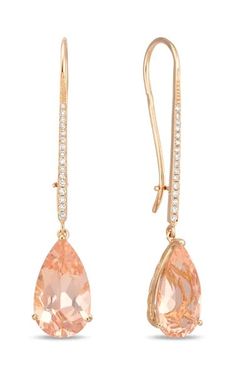 pair of gold earrings with morganite and diamonds on the ear wires, isolated against a white background