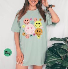 Make someone smile with this distressed smiley t-shirt from Comfort Colors. It would make a great gift for a friend or a sweet Mother's Day present! The soft-washed, garment-dyed fabric brings extra coziness to your wardrobe while the relaxed fit makes it an excellent daily choice. The double-needle stitching throughout the tee makes it highly durable while the lack of side-seams helps the shirt retain its shape. Features: .: 100% ring-spun cotton .: Medium fabric (6.1 oz/yd² (206.8 g/m .: Relax Fun Relaxed Fit T-shirt With Smiley Face, Playful White T-shirt With Smiley Face, Fun Cotton T-shirt With Smiley Face, Cheap Fun Smiley Face T-shirt, White Playful T-shirt With Smiley Face, Rebecca Black, Happy Shirt, Mothers Day Presents, Crew Neck Shirt