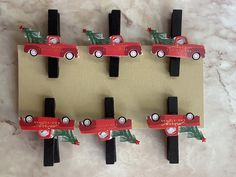 a set of four magnets with cars on them and christmas trees in the back