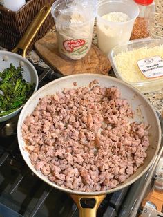 a pan filled with meat and vegetables on top of a stove next to other ingredients