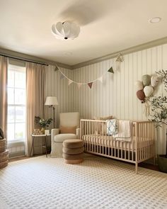 a baby's room with a crib and rocking chair