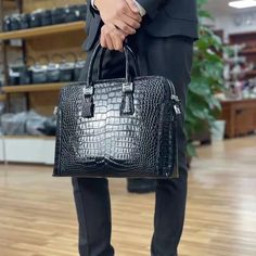 Amp up your trend with this essential crocodile-patterned briefcase. Crafted with genuine leather of the highest quality, it exudes luxury and sophistication. Designed as a solid pattern briefcase, it is perfect for men seeking style and functionality. The single strap ensures ease of carrying, making it ideal for business occasions. Elevate your style and make a statement with this must-have men's briefcase. Men's Briefcase, Business Briefcase, Leather Office, Office Bag, Crocodile Pattern, Briefcase For Men, Office Business, Crocodile Leather, Mens Luxury