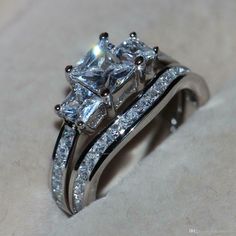 three stone ring set with diamonds on top