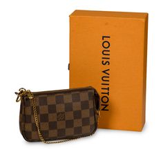 The Pochette is a petite accessory perfect to add to your Louis Vuitton day bag or simply wear it by itself if you only need a few items! The Pochette comes in the iconic Louis Vuitton damier ebene print recognisable anywhere. The gold chain that is attached as the top handle also detaches from one side, enabling you to hook it onto other accessories. Style your mini Pochette with your Louis Vuitton day bag. SPL Exterior Monogram Canvas Gold toned hardware Gold chain detachable from one side Zipped closing Brown leather trim Very good condition - minimal signs of use present throughout Interior Red canvas lining Very good condition - very light signs of marks and use on inner lining Sold with dustbag and box SPL Height: 10.5cm Width: 15.5cm Depth: 3cm Red Canvas, Accessories Style, Louis Vuitton Damier Ebene, Dior Shoes, Damier Ebene, Brown Canvas, Timeless Handbag, Day Bag, Luxe Fashion