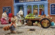 three stuffed animals are standing in front of the corner shop with food and toys on display