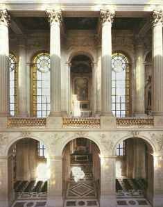 the interior of a building with columns and windows