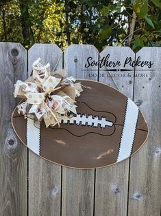 a wooden sign with a football on it