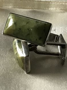 Vintage cufflinks with a olive green semi precious stone. Stone could be some kind of jasper although not absolutely sure. They are set in sterling and hallmarked. They look like a modern design so they could be as early as the 1930's Art Deco period or modern Mid Century. In any case they are good looking with simple classic lines. Feel free to convo me with any further questions. Thank you for your interest. Classic Green Cufflinks For Formal Occasions, Classic Green Cufflinks For Gift, Classic Green Cufflinks As Gift, Quartz Crystal Jewelry, Music Box Jewelry, Modern Mid Century, Vintage Cufflinks, 1930s Art Deco, Crystal Choker