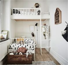 there is a bunk bed in the corner of this room with toys on the floor