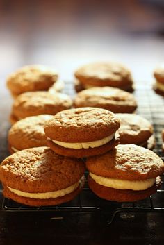 several cookies are stacked on top of each other with frosting in between the cookies