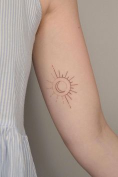 a woman with a sun tattoo on her arm