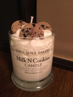 a glass jar filled with cookies on top of a wooden table