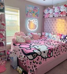 a bedroom with hello kitty bedding and stuffed animals