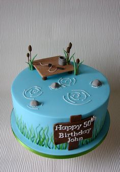 a blue birthday cake decorated with an image of a boat in the water