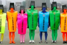 five people in colorful plastic bags standing next to each other