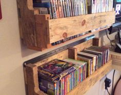 a wooden shelf filled with dvd's on top of a wall