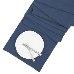 a white plate with silverware on top of it next to napkins and forks