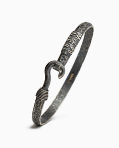 A Vibe signature, the Pirate Texture Fish Hook Bracelet is fashioned in oxidized sterling silver with a fish hook clasp. Our signature pirate texture gives a rugged, weathered look to the piece. Featuring the St. John coordinates and seven 14K gold good luck wraps, solo or stacked, it is sure to be a favorite statement piece. Found in many of our designs, Vibe’s seven good luck wraps represent love, laughter, happiness, good fortune, health, unity, and peace. In Caribbean tradition, the fish hoo Hook Bracelet Caribbean, Elegant Metal Jewelry With Fish Hook, Silver Necklace With Fish Hook Clasp Gift, Mens Bracelet With Fish Hook, Metal Fish Hook Earrings, Fish Hook Bracelet, Hook Bracelet, Gold Wrap, The Pirate