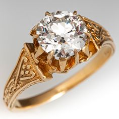 an antique style diamond ring with filigree accents