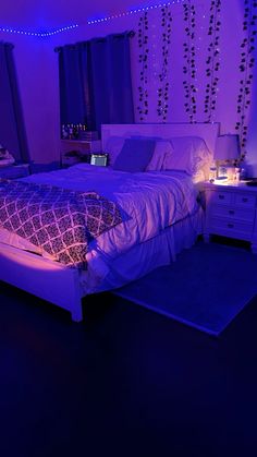 a bed in a room with purple lights on the walls and blue carpeted floor