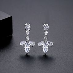 Accent your ears with the shining style of these floral stud earrings featuring cubic zirconia embellishments. 0.55" W x 1.02" L Silver-plated copper / crystal / cubic zirconia Diamond White Crystal Drop Earrings With Cubic Zirconia, Elegant Cubic Zirconia Flower-shaped Crystal Earrings, Elegant Flower Shaped Cubic Zirconia Crystal Earrings, Elegant Crystal Flower Shaped Earrings, Elegant Flower Shaped Crystal Earrings, Formal Dangle Flower Earrings With Cubic Zirconia, Sparkling Cubic Zirconia Drop Clip-on Earrings, Cubic Zirconia Clip-on Drop Earrings With Sparkling Stones, Formal Cubic Zirconia Flower Drop Earrings