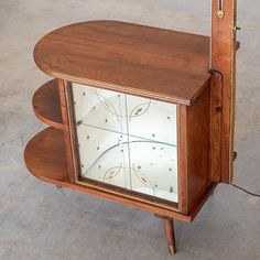 an old wooden clock with glass in the middle and wood trim around it's sides