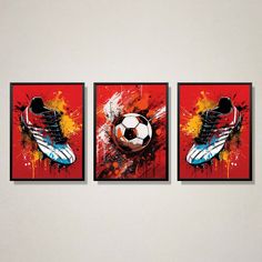 three soccer paintings on a wall in a room