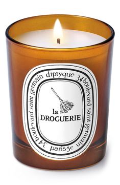 a candle that is sitting in front of a white background with the words la droguerie on it