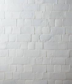 a white brick wall with no mortars on it