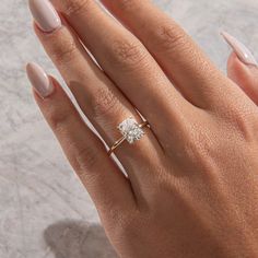 a woman's hand with a diamond ring on it