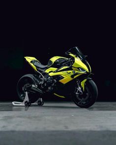 a yellow and black motorcycle is parked in the dark