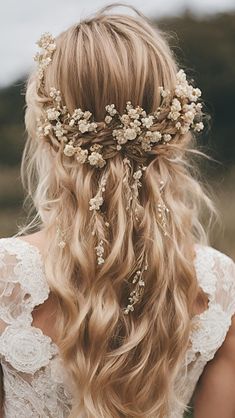 a woman with long blonde hair and flowers in her hair is wearing a flower crown