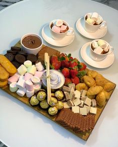 a table topped with lots of different types of desserts and pastries on plates