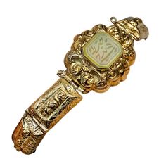 An ornate hollow 18K gold bracelet with embossed and hand engraved decorations is set with an octagon cut jade engraved with an unidentified Eastern script. Weight 14.86 grams Length 16,5 cm (6 3/4 in.) Regency Jewelry, Bracelets Green, 18k Gold Bangle, Georgian Jewelry, Hamsa Bracelet, 18k Gold Bracelet, Georgian Era, Carved Jade, Antique Gold Jewelry