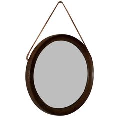 a round mirror hanging on a wall