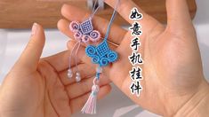 two hands holding small crocheted items with chinese writing on the bottom and below