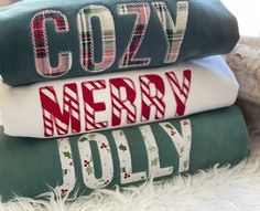 three christmas blankets stacked on top of each other with the words cozy merry holly written in red