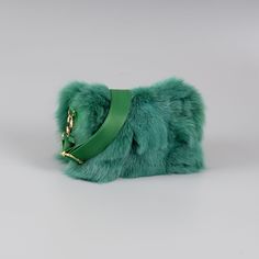 Fox fur shoulder bag with leather details in green color. This bag has a wide internal space, a detachable and adjustable strap, a zipper closure, and leather details all over. Furthermore, the green fox fur shoulder bag will stand out with its spaciousness and soft touch. The bag manufactures in our company in Greece with high-quality fox fur and leather. Fur: Fox Leather: Yes Color: Green Length: 27 cm (10,6 in) Width: 15 cm (5,9 in) Height: 15 cm (5,9 in) Lining: 100% Polyester Detachable str Luxury Shoulder Bag With Faux Fur Lining, Luxury Faux Fur Shoulder Bag With Fur Lining, Luxury Faux Fur Shoulder Bag, Luxury Faux Fur Rectangular Shoulder Bag, Luxury Rectangular Faux Fur Shoulder Bag, Luxury Faux Fur Shoulder Bag For Everyday Use, Fur Bag, Sling Bags, Fox Fur