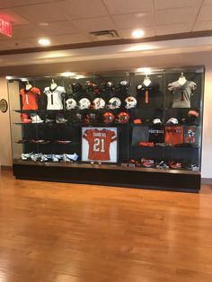 the display case is filled with football memorabilia