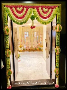 an entrance decorated with flowers and greenery