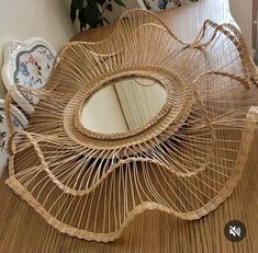 a mirror sitting on top of a wooden table