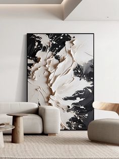 an abstract painting hangs on the wall next to two chairs and a coffee table in a modern living room